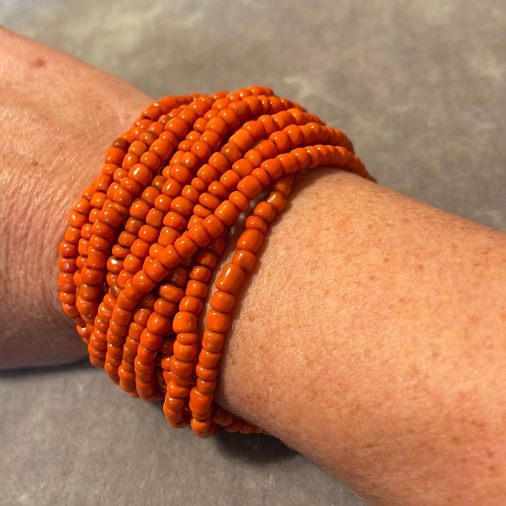 Orange beaded bracelet with wooden closure